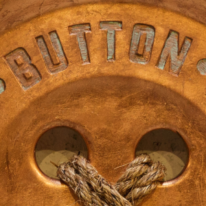 Close up of the Mountable Copper Leaf Button ionized lettering